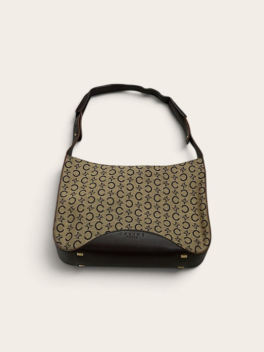 Round Retail vintage Celine Macadam canvas shoulder bag with brown leather trim and gold hardware details.